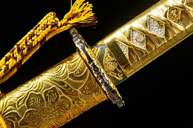 High-resolution macro photo of the polished 1060 carbon steel katana blade showing the hamon (temper line).