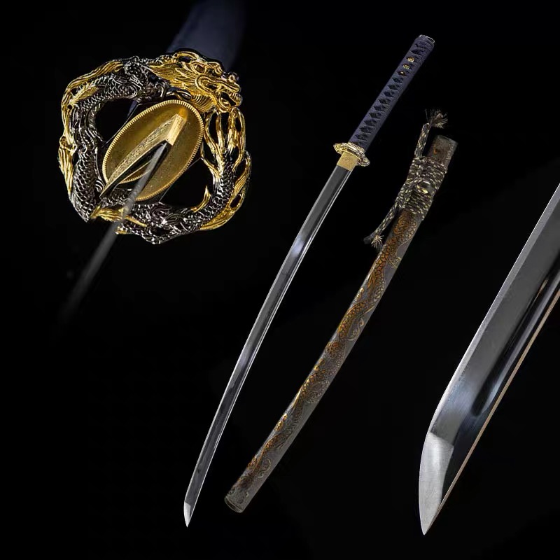 Detailed close-up photo of the intricately carved gold and silver dragon tsuba and gold-plated habaki on a custom Japanese katana sword from Safe Haven Armor.