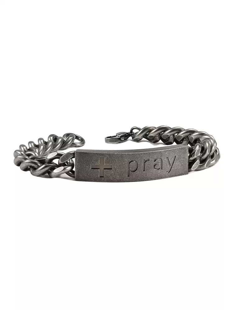 A side perspective shot of the mens silver motorcycle chain bracelet with a curved engraved cross and pray ID tag plate.