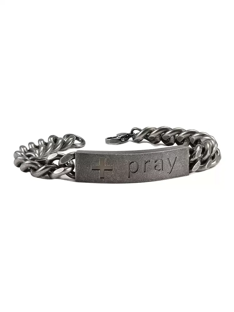 A side perspective shot of the mens silver motorcycle chain bracelet with a curved engraved cross and pray ID tag plate.