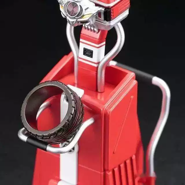 A macro shot of a black motorcycle tire tread ring displayed within a custom red and silver futuristic-style product holder.
