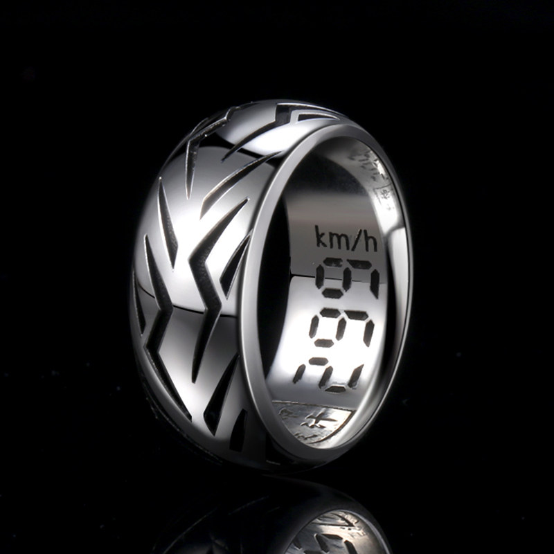 A polished silver motorcycle tire tread ring showcasing the textured tire pattern on the outside and a 299 km/h speedometer engraving on the inside.