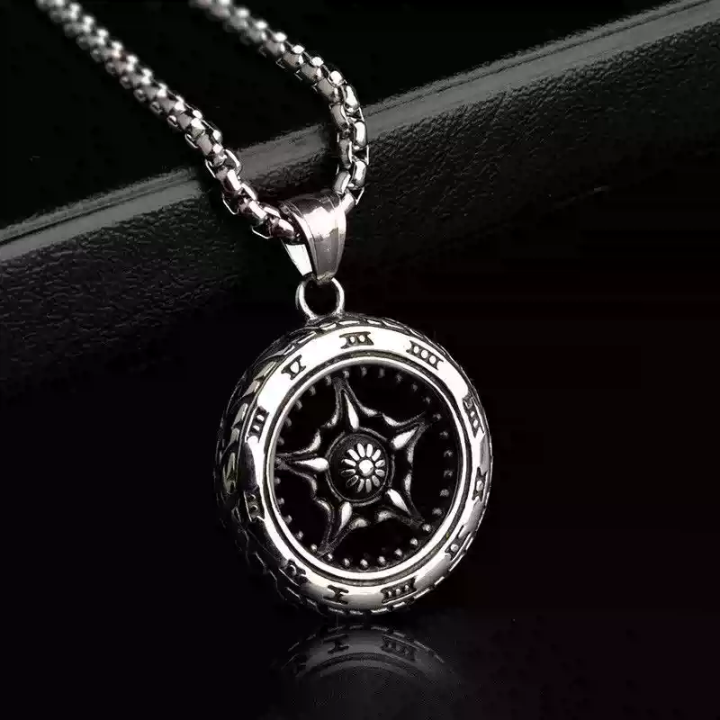 Close-up shot of the intricate five-spoke center hub design of the silver motorcycle wheel necklace.