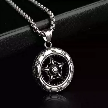 Close-up shot of the intricate five-spoke center hub design of the silver motorcycle wheel necklace.