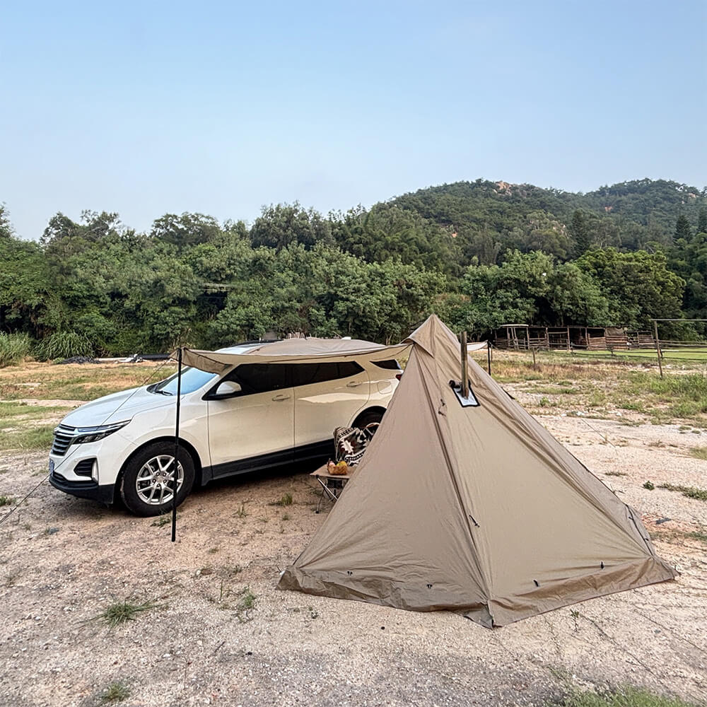 A pyramid hot tent and an SUV with an attached car awning, demonstrating a versatile car camping setup.