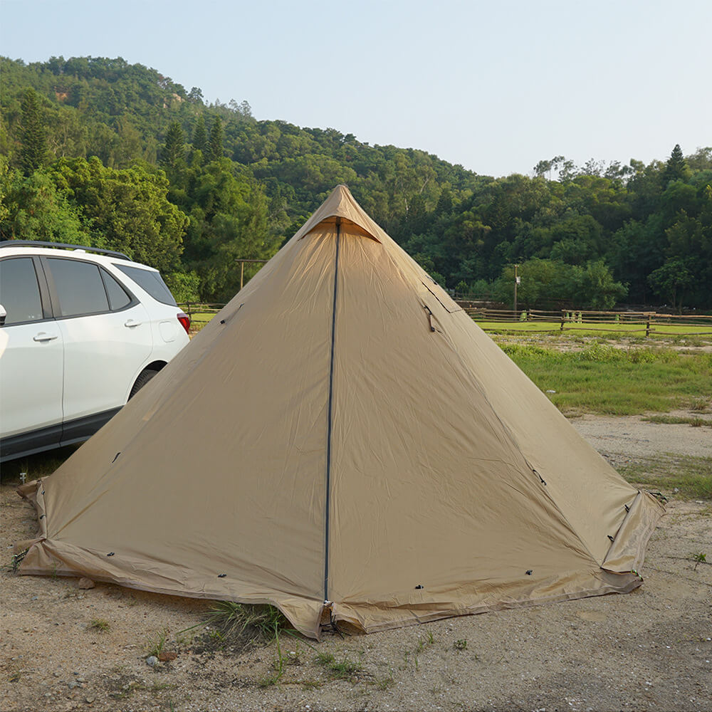 Full view of the pyramid tent next to an SUV, emphasizing its compact and portable design for car camping.