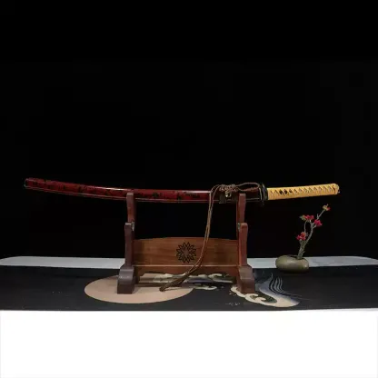 Full view of a sheathed Rurouni Kenshin katana with a red and black lacquered scabbard on a wooden display stand.