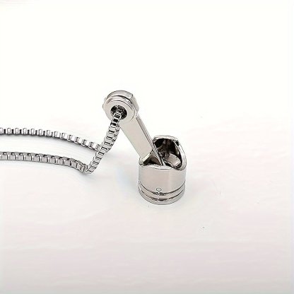 A silver stainless steel motorcycle piston pendant necklace showcasing a punk style design on a white background.