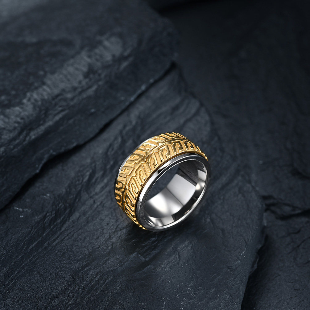 A two-tone gold and silver biker spinner ring with realistic tire tread engravings.