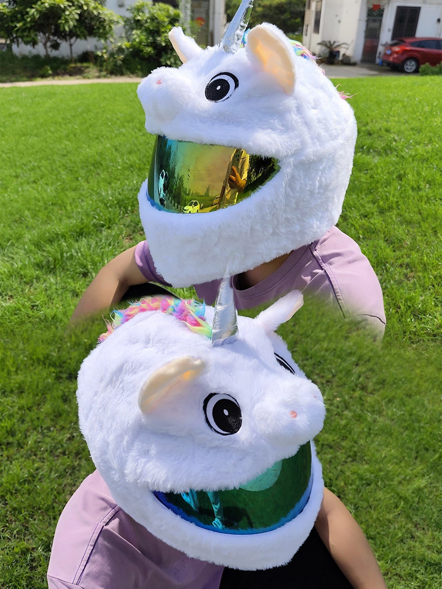 White Unicorn motorcycle helmet cover with a rainbow braided mane and a silver horn, shown on a rider in a sunny outdoor setting.