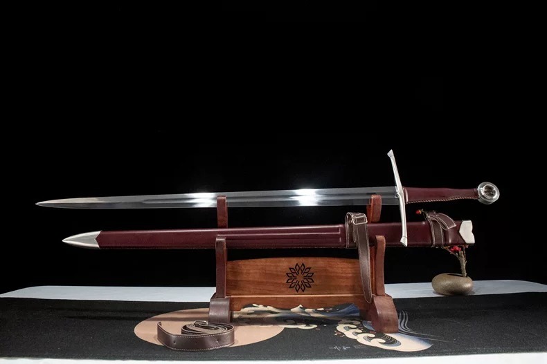 Unsheathed battle-ready medieval longsword resting on a display stand, highlighting the blade profile.
