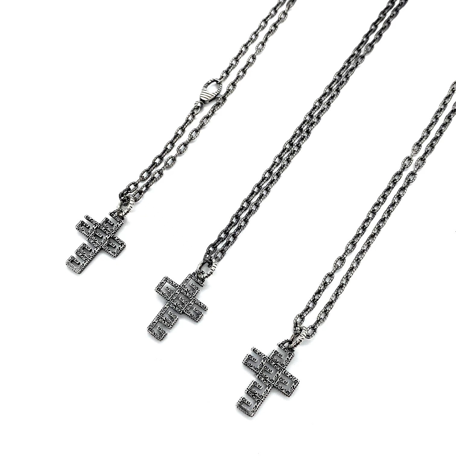 Gucc* の G 文字入りの十字架型の透かし彫りネックレス