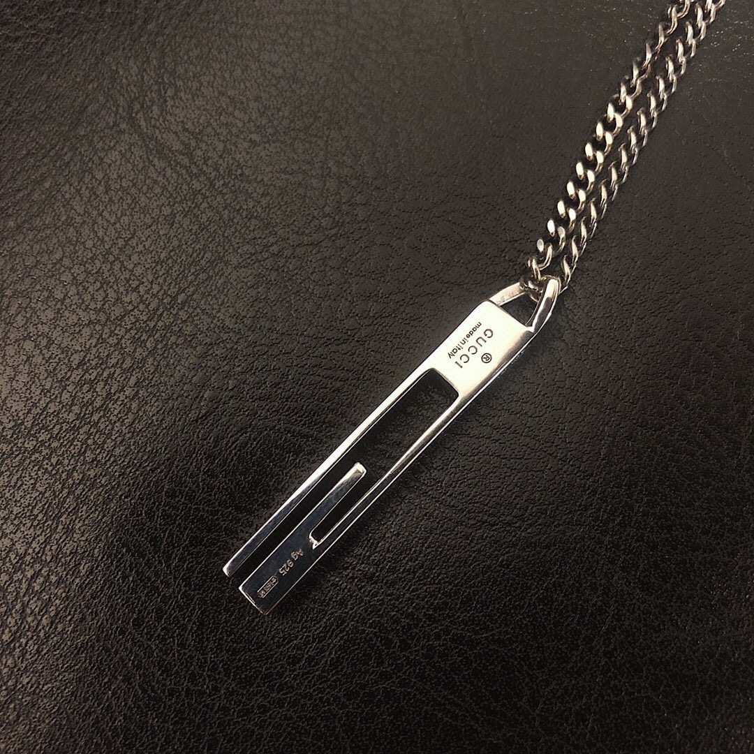 Gucc* のカップル用 G 文字入りの縦長ペンダント