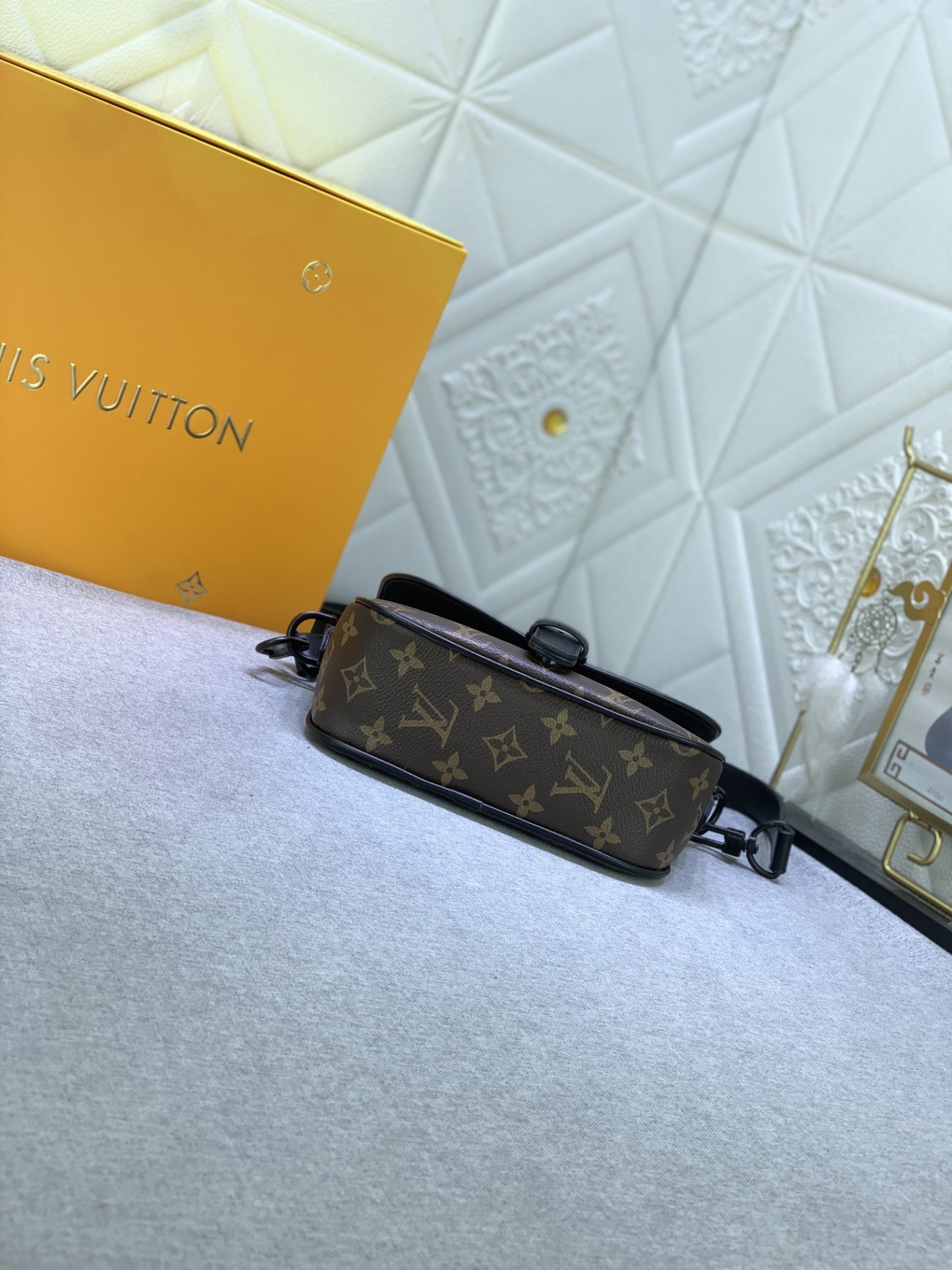 M47060 の老花（モノグラム）と圧花のメンズポストバッグシリーズ、MONTSOURIS の小サイズ