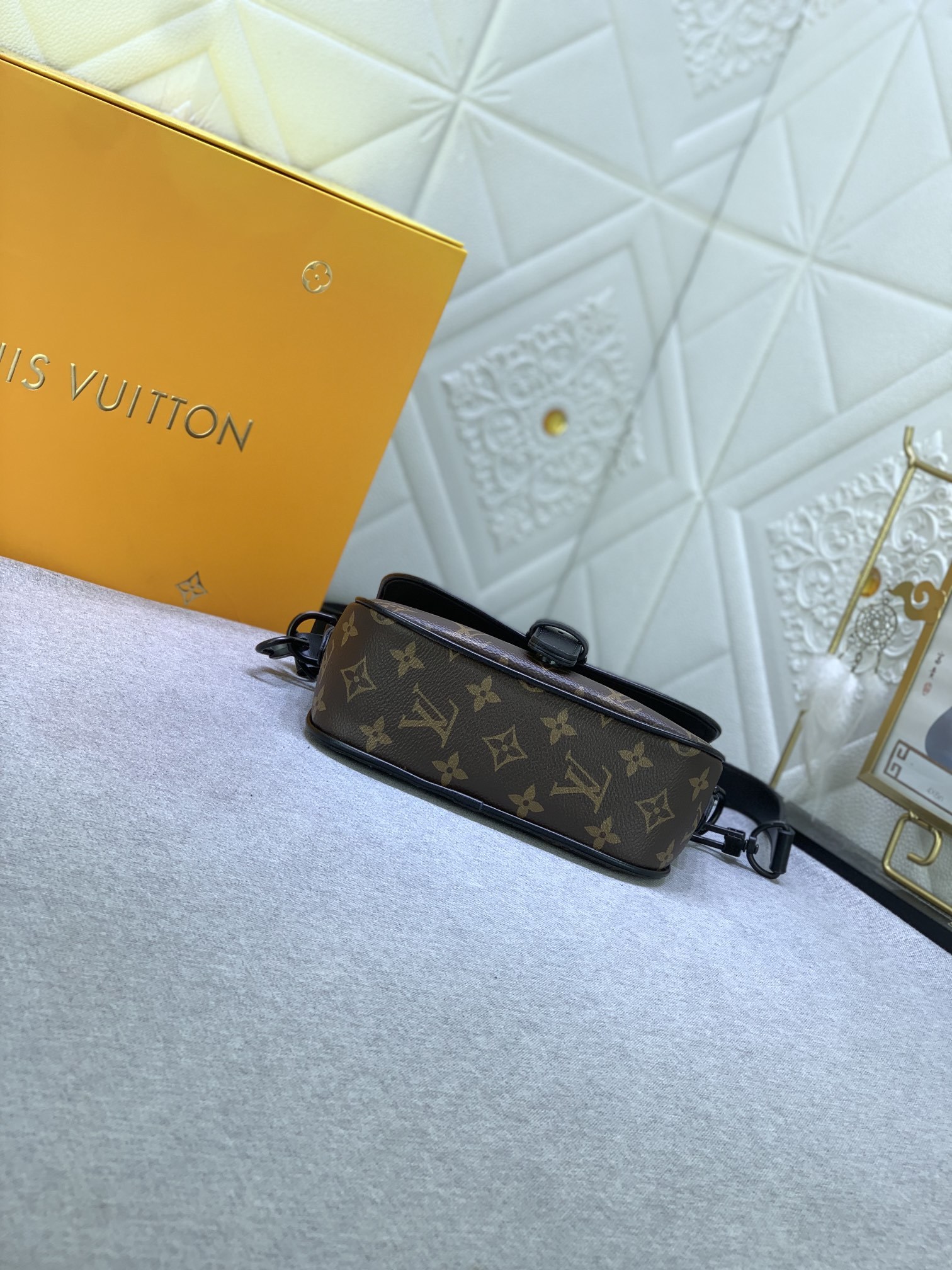 M47060 の老花（モノグラム）と圧花のメンズポストバッグシリーズ、MONTSOURIS の小サイズ