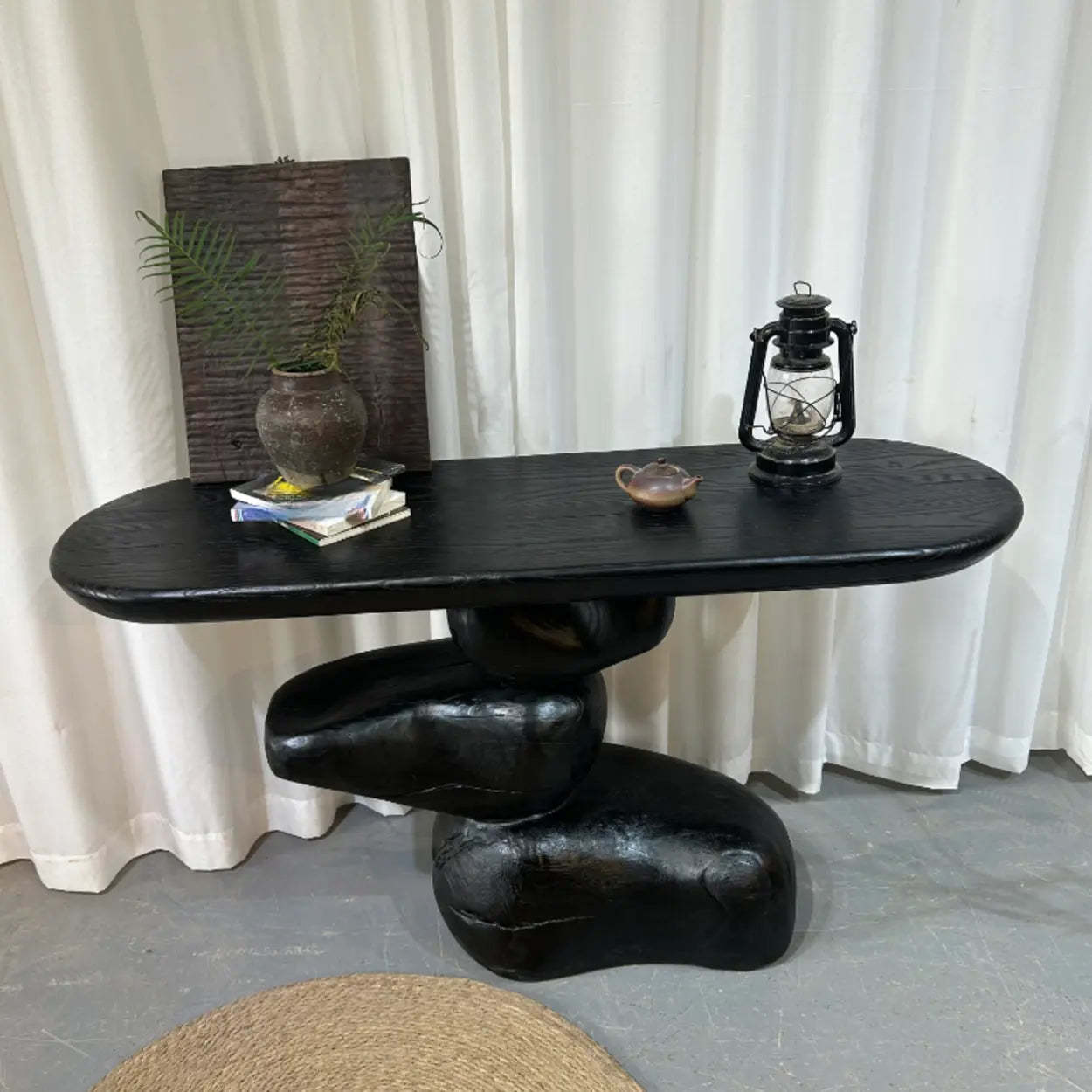 Artistic Pebble Base Black Wood Console Table