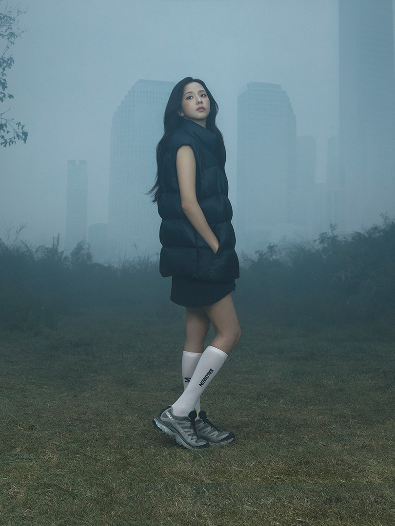 JISOO wearing XT-4 OG GORE-TEX in a misty city landscape