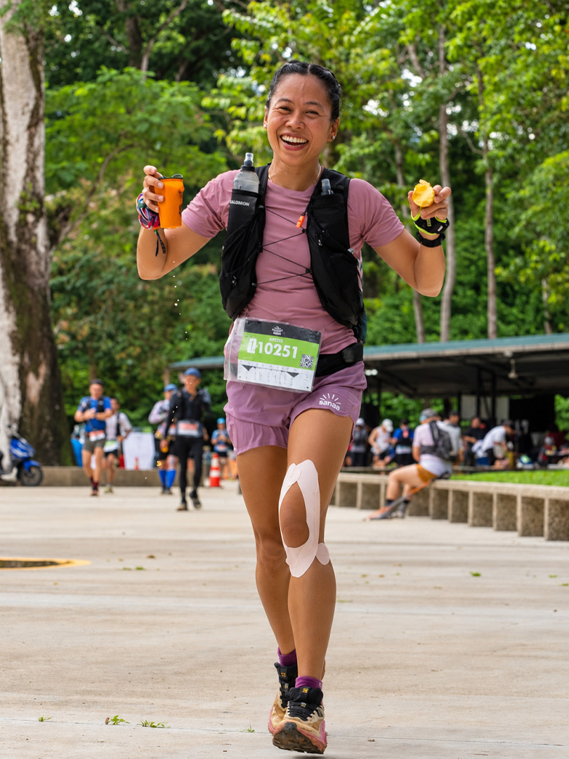 Elite trail runner Angge Cabalo smiling at a running event