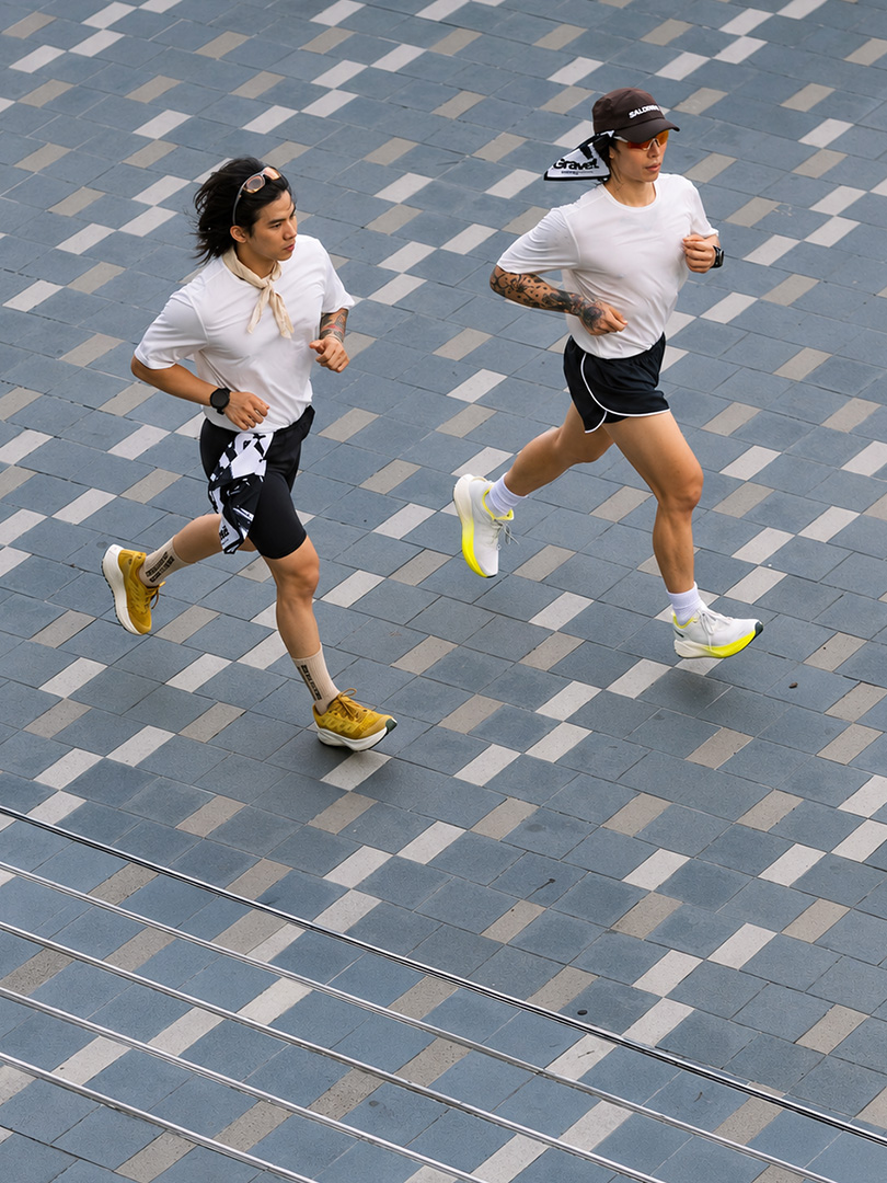Two BNDN Run Club runners on a paved route
