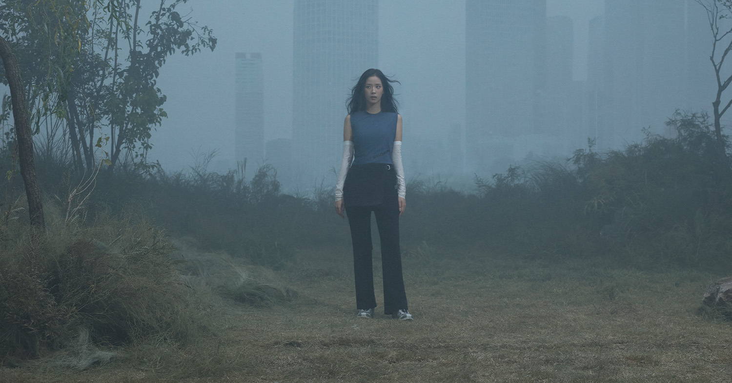 JISOO in a misty landscape between city and nature