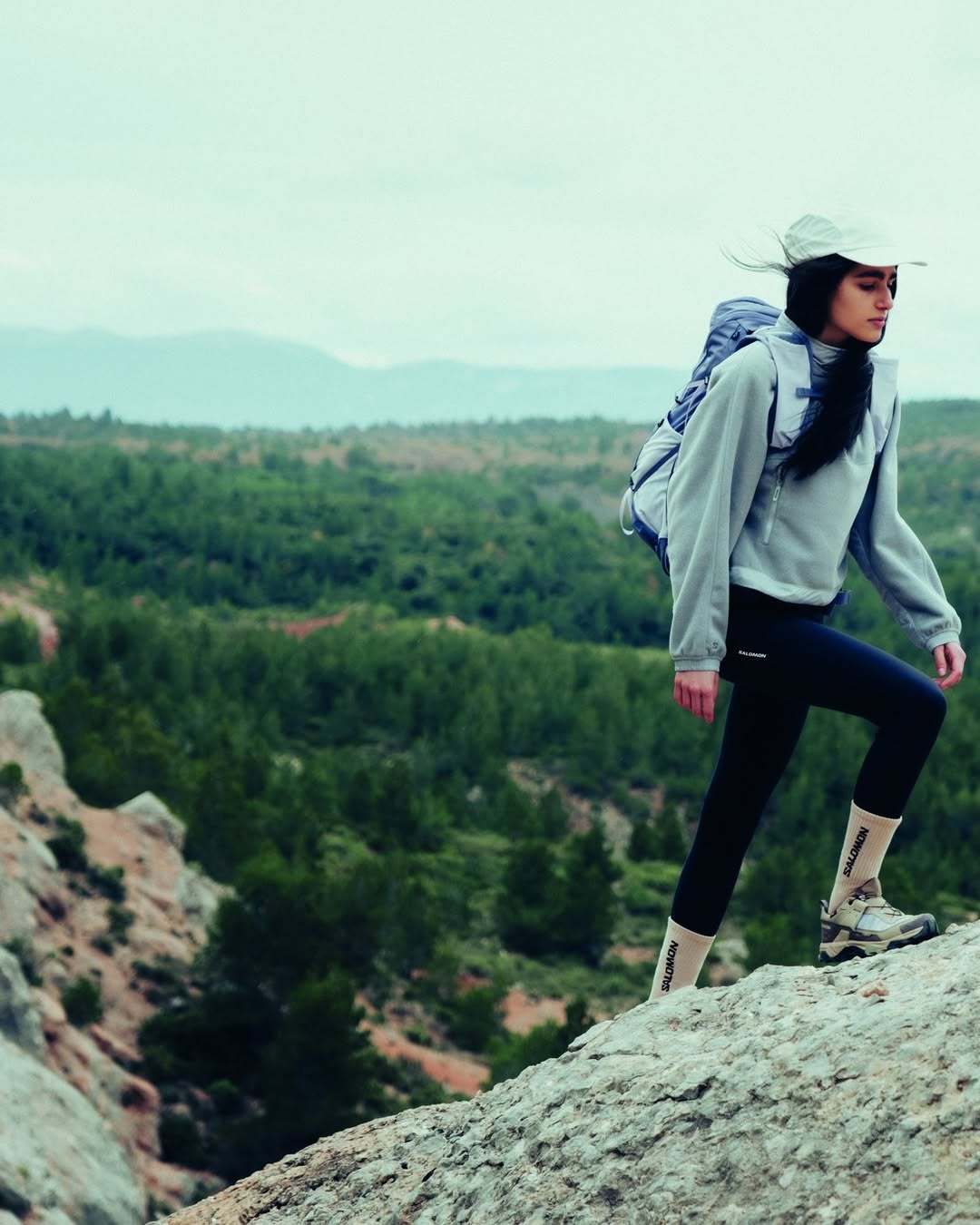 Hiker wearing Salomon X Ultra shoes on a rocky ridge