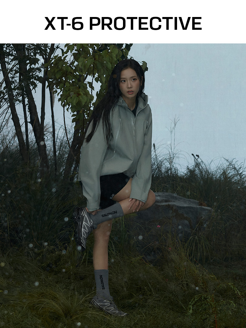 JISOO wearing XT-6 PROTECTIVE in a misty outdoor landscape