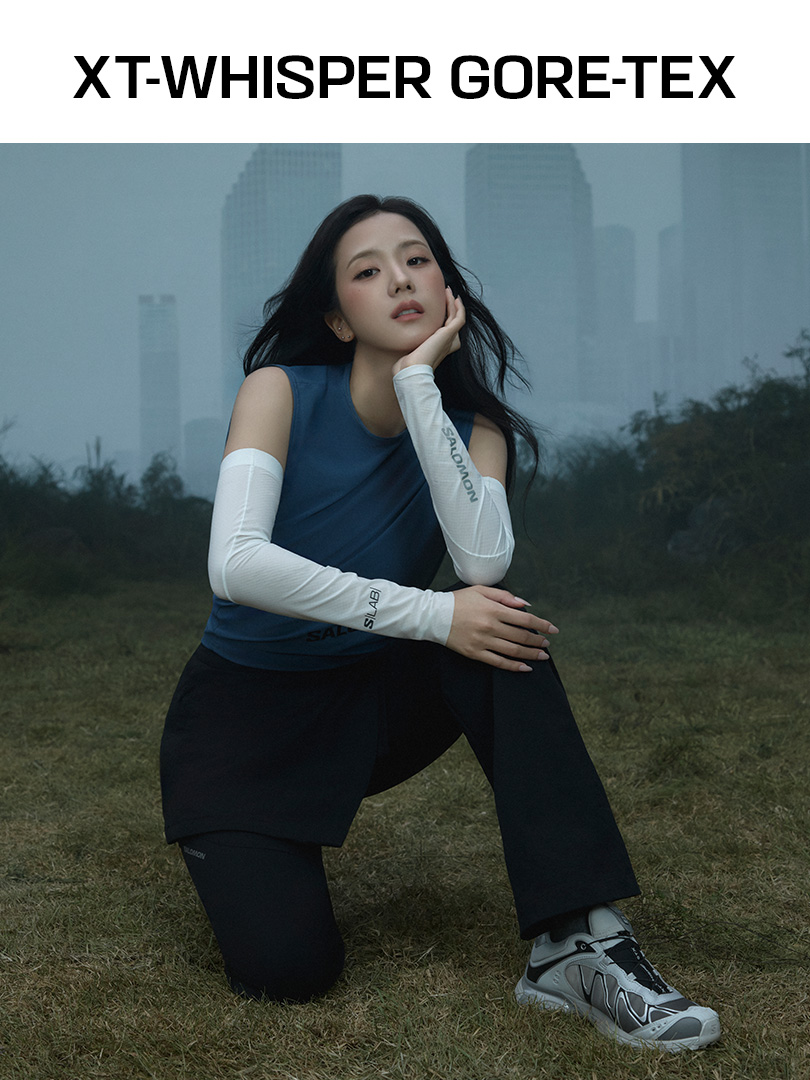 JISOO wearing XT-WHISPER GORE-TEX in a misty urban landscape