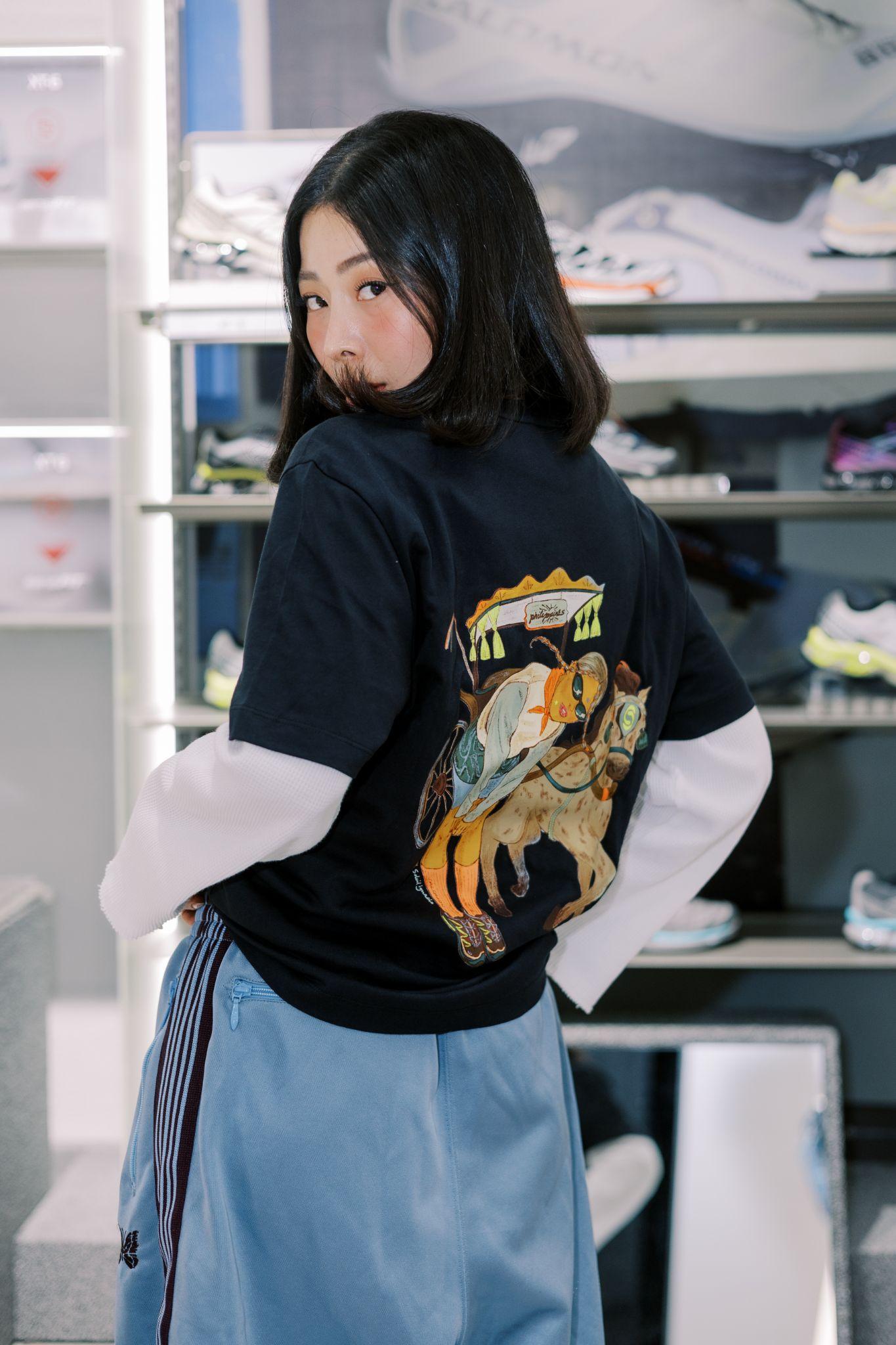 Content creator Rhea Bue wearing the limited Salomon Manila logo tee designed by Soleil Ignacio