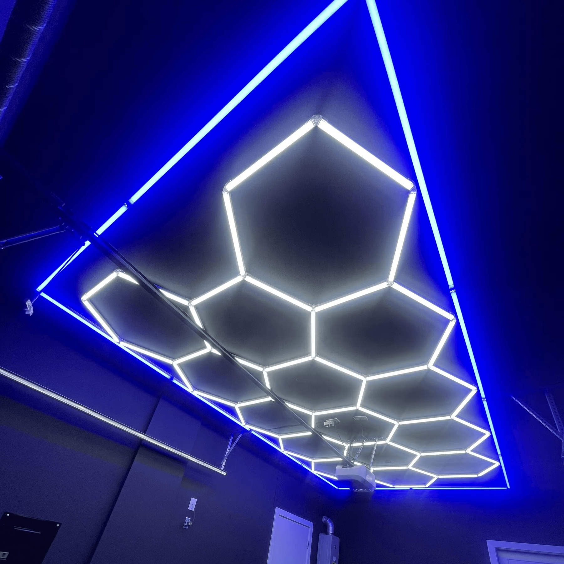 Ceiling mounted honeycomb LED light with blue border for private garage