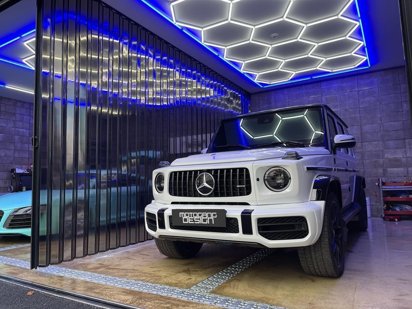 Blue framed hexagon LED lighting for professional car modification workshop