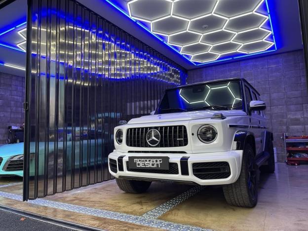 Blue framed hexagon LED lighting for professional car modification workshop