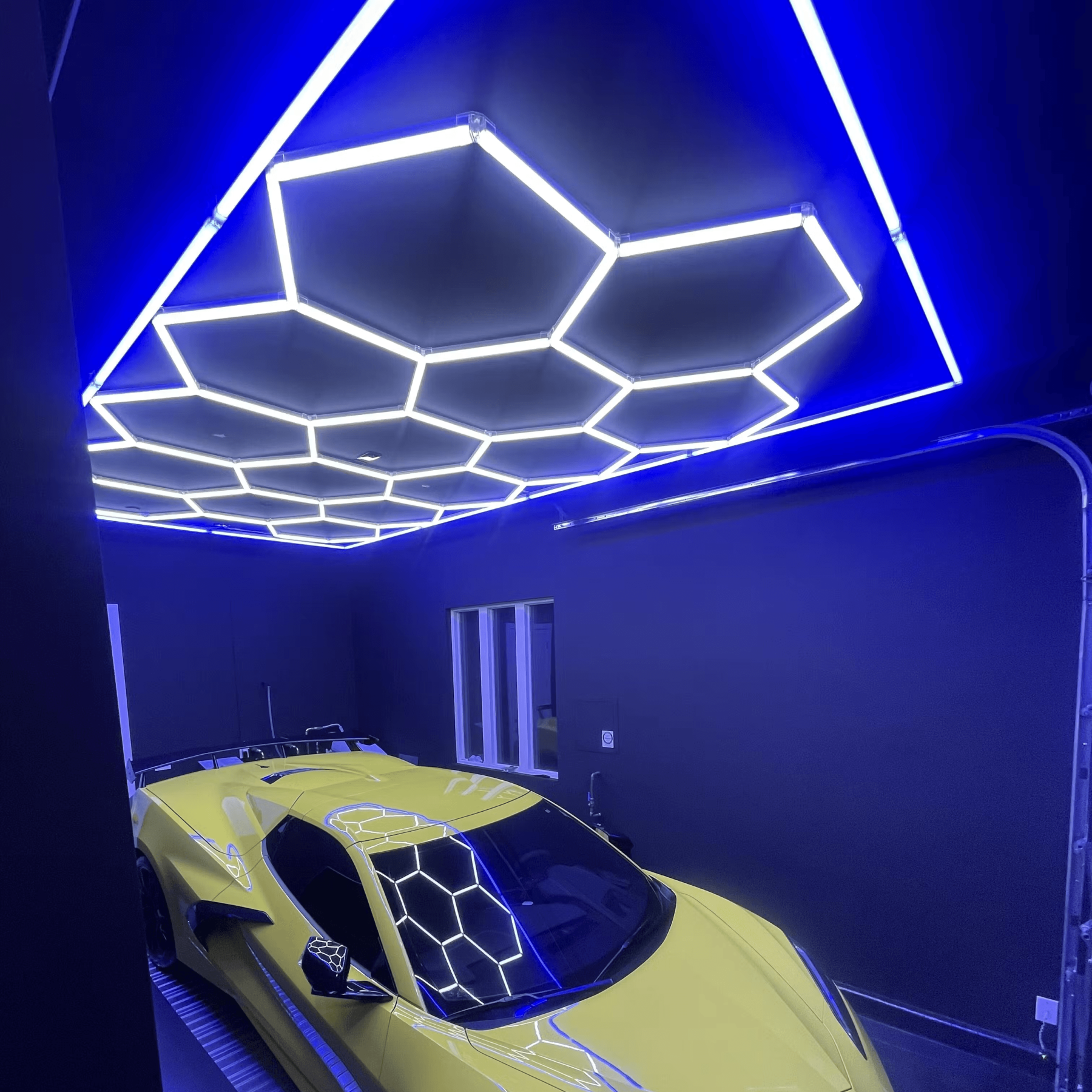 Honeycomb LED lighting with blue frame for clean and organized garage