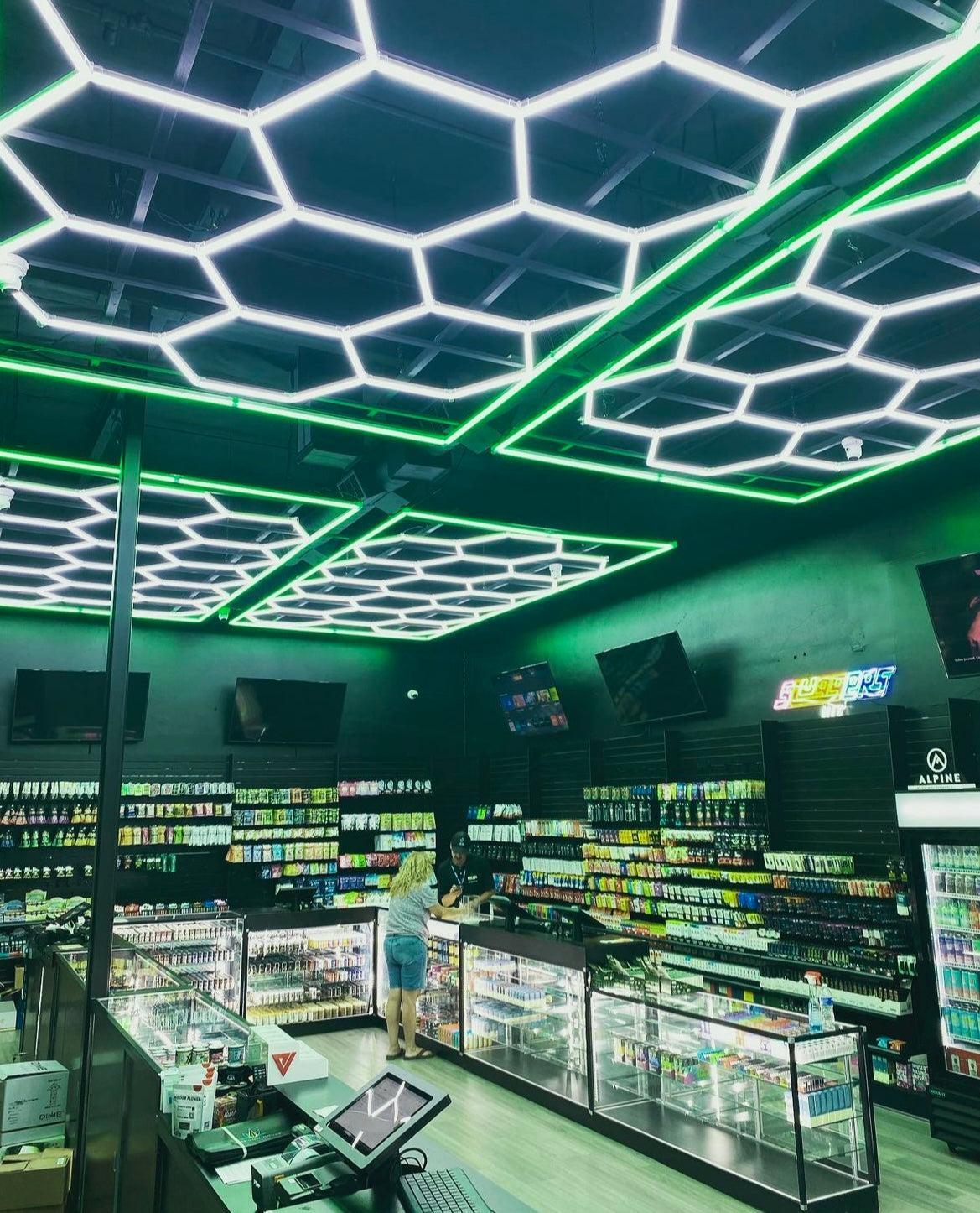 Green bordered hexagon LED light creating inviting atmosphere in small shop