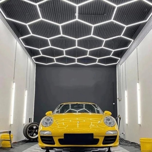 Clean and modern hexagon LED lighting in huge automotive shop
