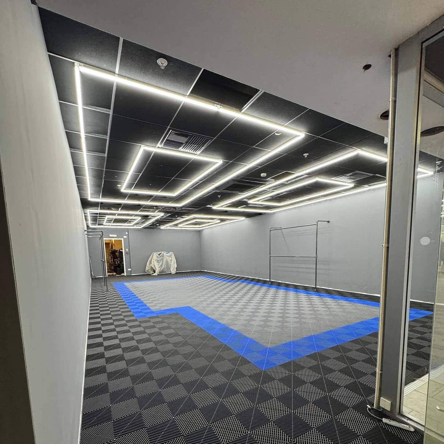 Rectangle LED ceiling light illuminating exhibition space
