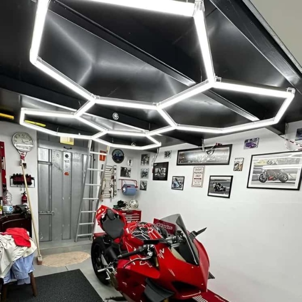Bright white hexagon LED light covering entire garage space
