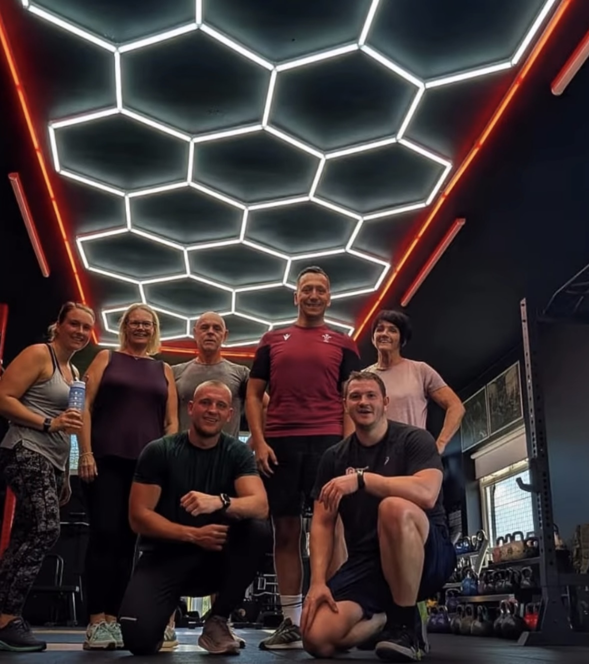 Red bordered hexagon LED light illuminating vibrant fitness gym