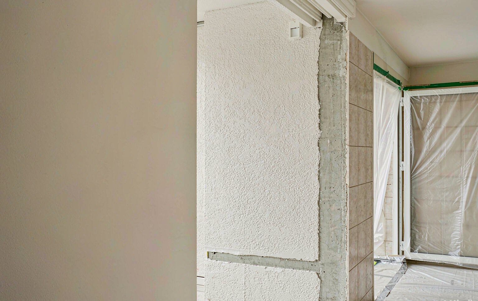 A wall carefully stripped back with clean cut edges and full floor protection