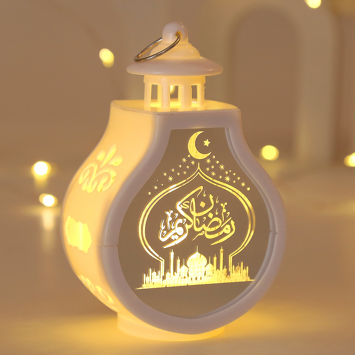close-up laser carved crescent mosque arabic pattern translucent panel warm light effect