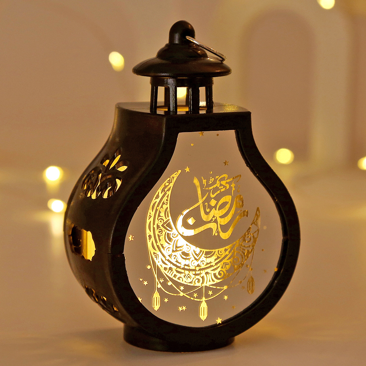 single gold ramadan led lantern placed on dining table with eid balloon backdrop
