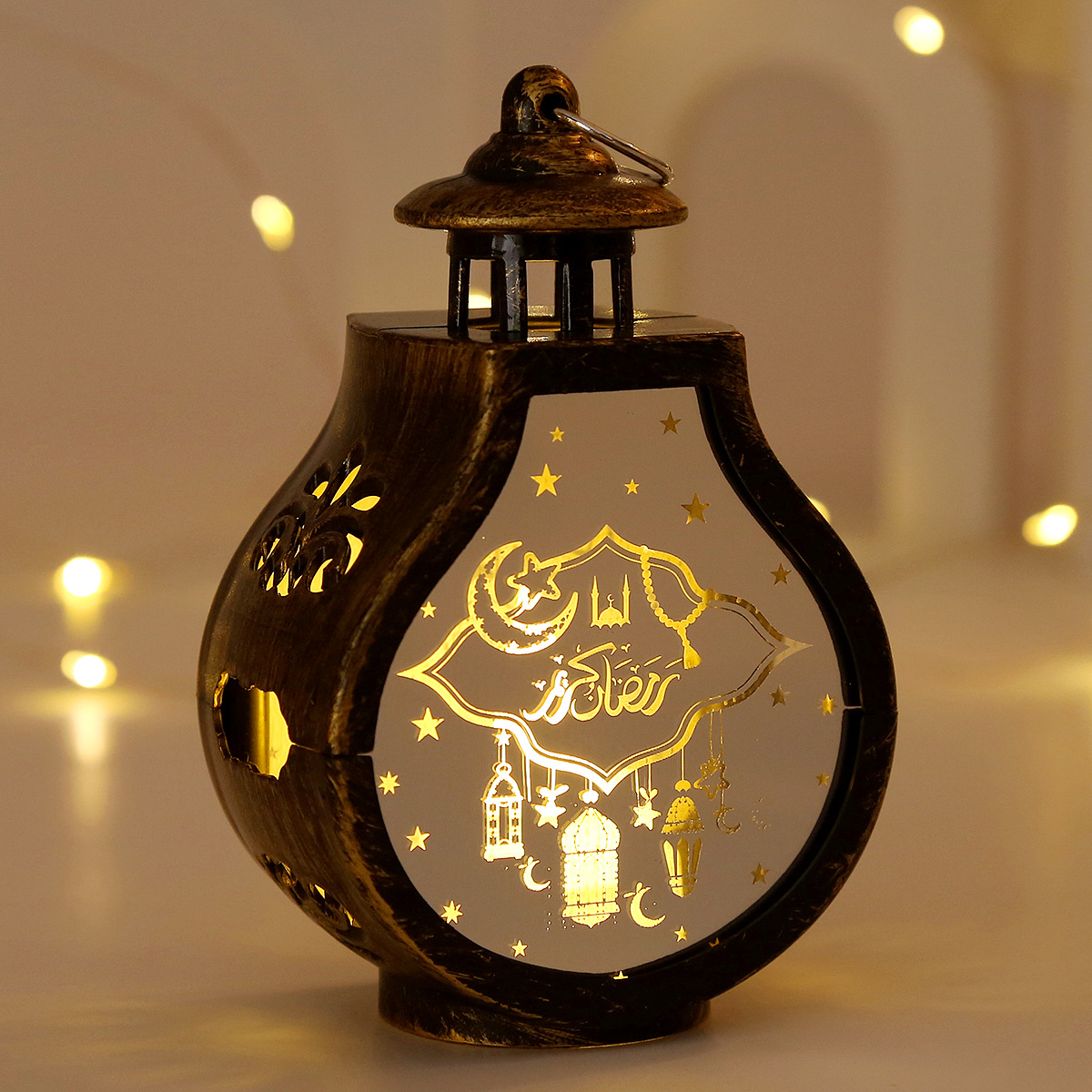 close-up laser carved crescent mosque arabic pattern translucent panel warm light effect