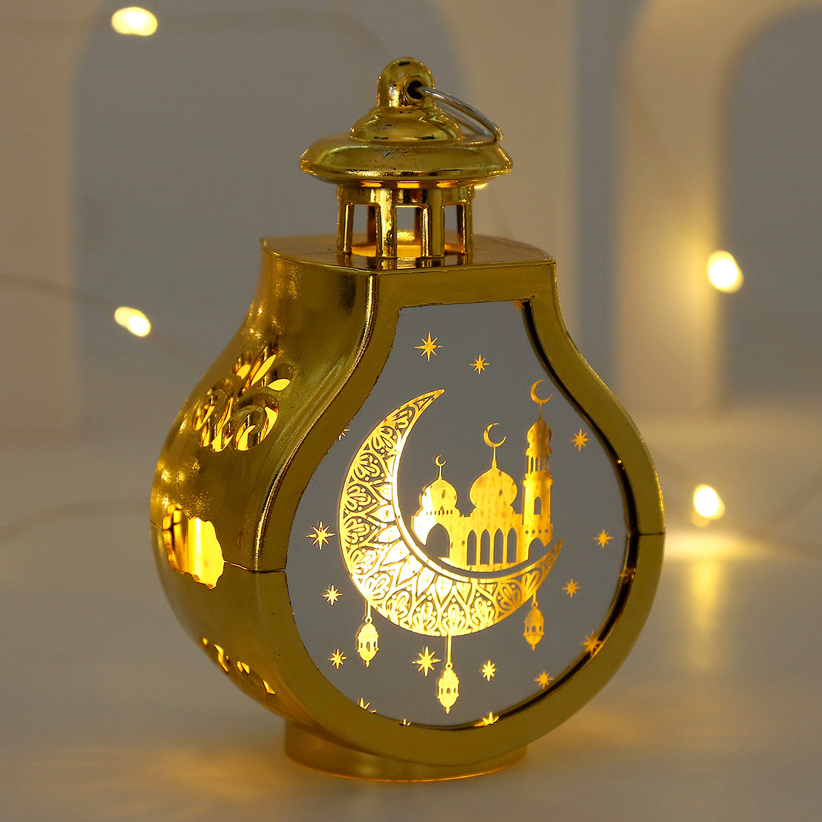 close-up laser carved crescent mosque arabic pattern translucent panel warm light effect