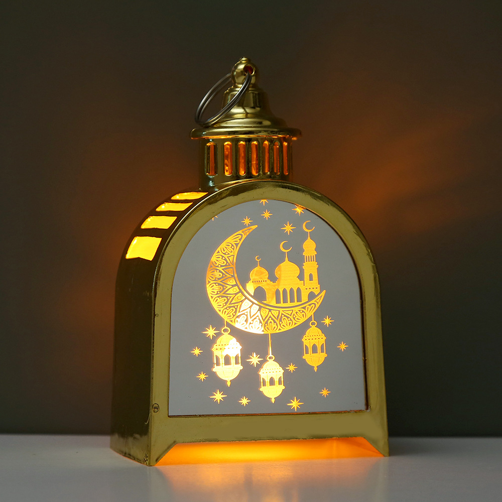 Four arch ramadan lanterns arranged on white desktop with book background