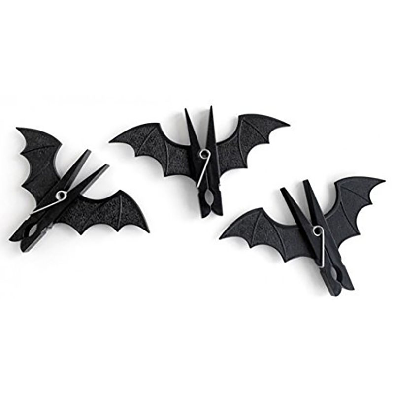 three black bat wooden peg clothespins flat lay white background product shot