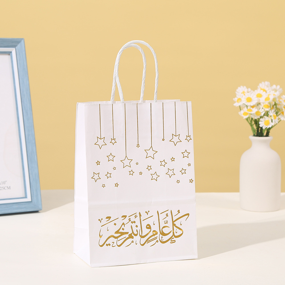 Close-up of shiny gold foil arabic calligraphy and star pattern on paper bags