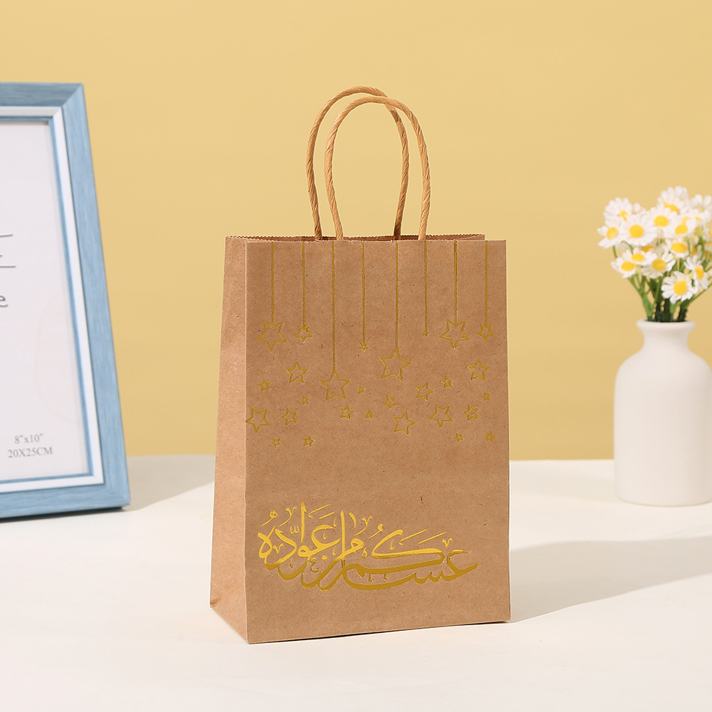 Close-up of shiny gold foil arabic calligraphy and star pattern on paper bags