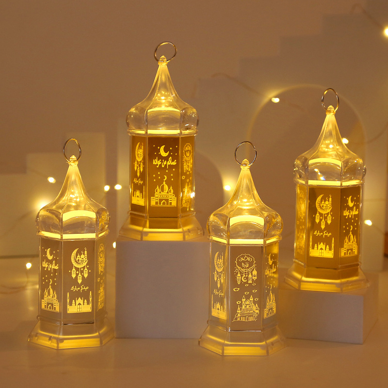 Four transparent octagon tower ramadan eid led lantern lit warm light display on white shelf
