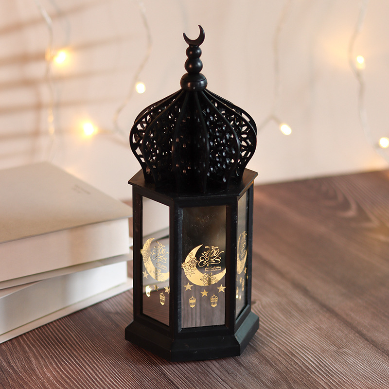 White ramadan lantern placed beside books, fairy light background home decor shot