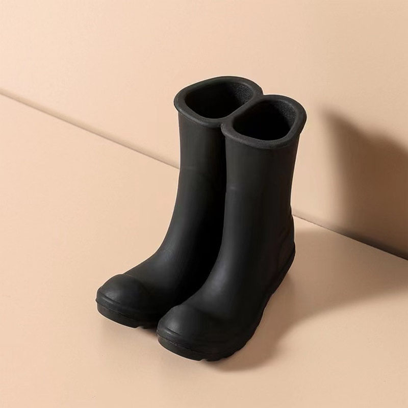 bright red twin connected mini rain boots silicone pen holder beige desktop background product shot