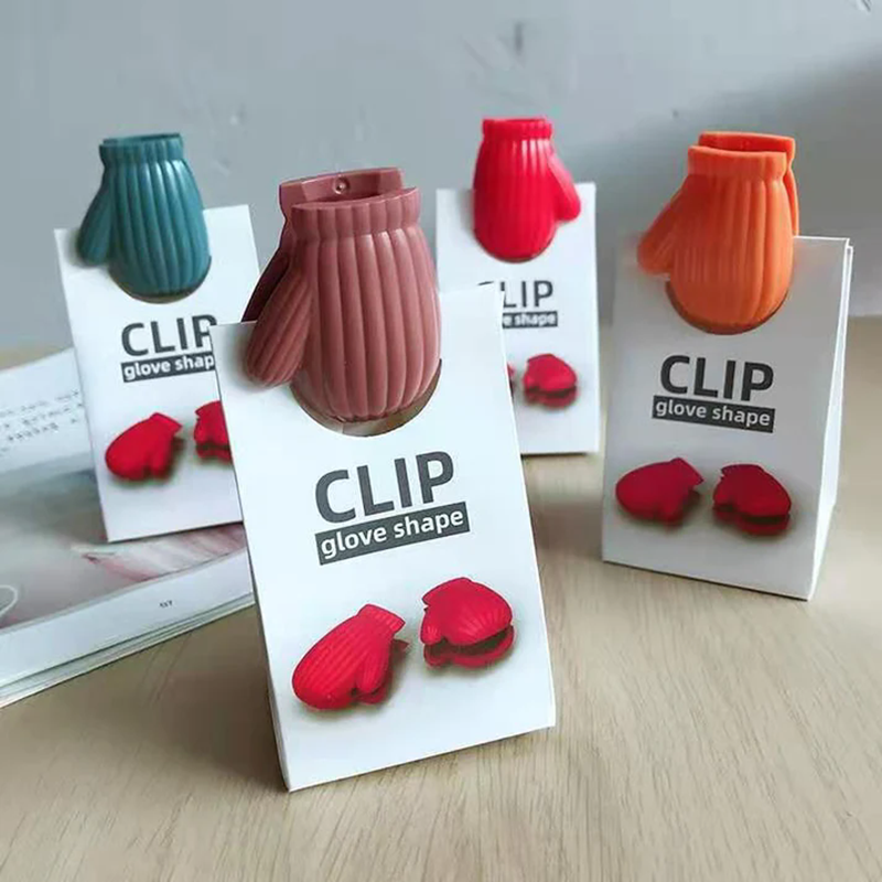 multi color knitted texture winter glove mitten plastic bag clip retail card packing wooden table scene